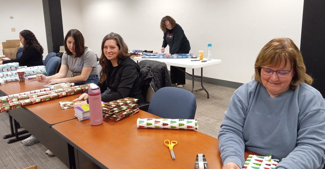 bmm team members wrapping gifts